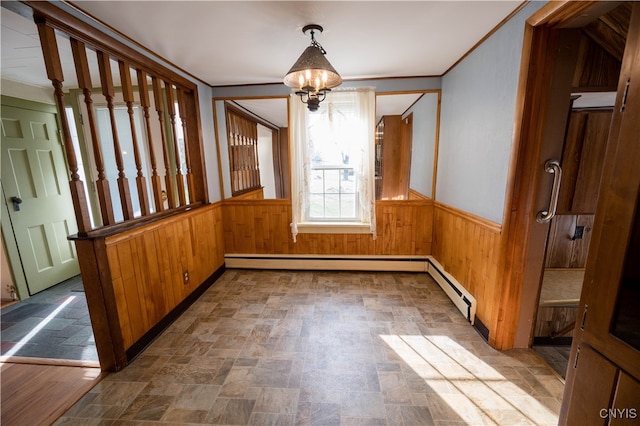 unfurnished dining area featuring a chandelier and wood walls