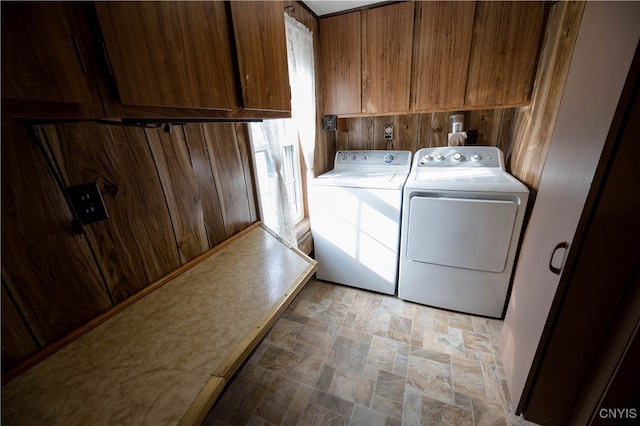 laundry area featuring separate washer and dryer and cabinets