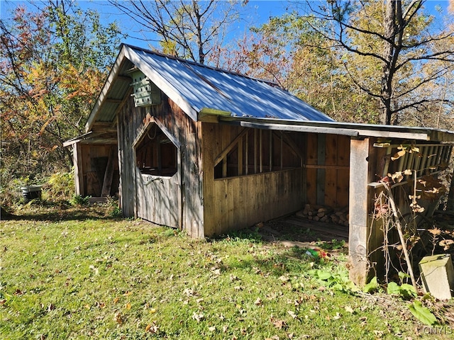 view of outbuilding with a lawn