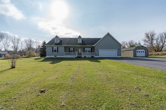 new england style home with a front lawn, covered porch, and a garage