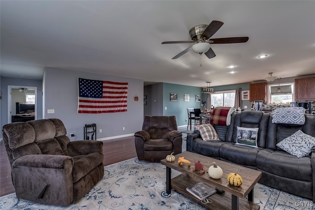 living room featuring light wood-type flooring and ceiling fan