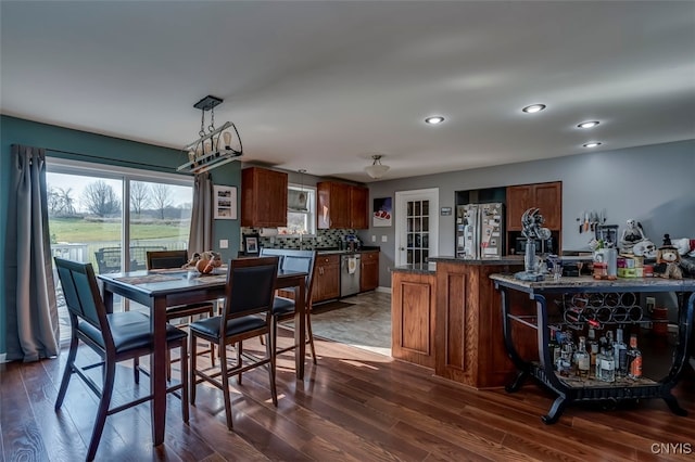 dining space featuring dark wood-type flooring