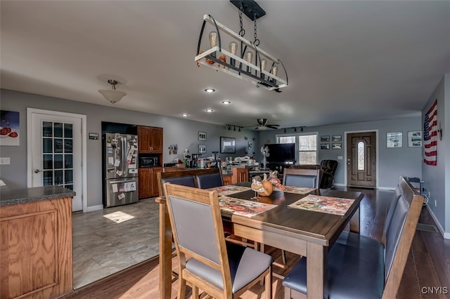 dining space with hardwood / wood-style floors and ceiling fan