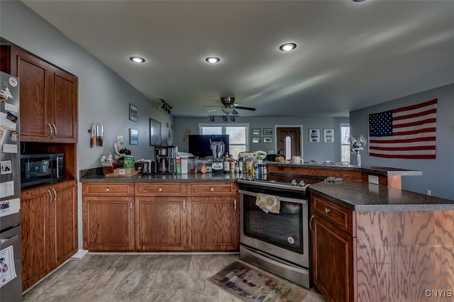 kitchen with kitchen peninsula, ceiling fan, and electric stove