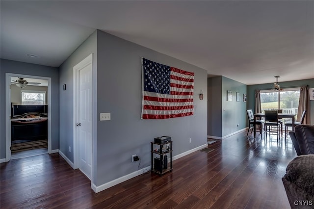 interior space with ceiling fan, dark wood-type flooring, and a wealth of natural light