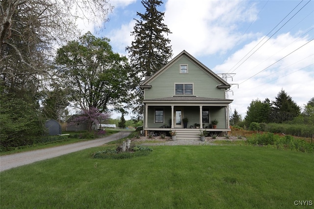 back of property featuring a yard and a porch