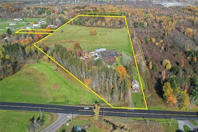 birds eye view of property with a rural view