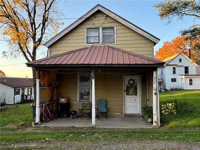 view of front of house with a lawn and a porch