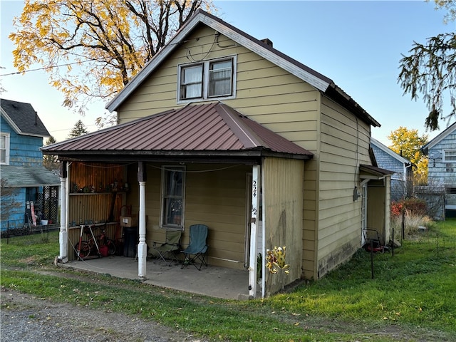 back of property featuring a yard