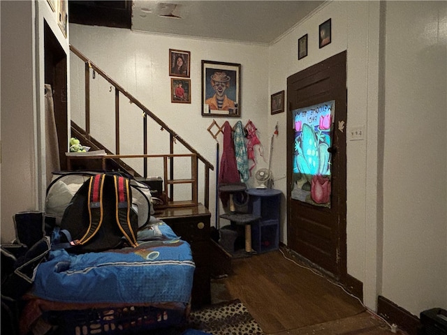 entrance foyer with crown molding and wood-type flooring