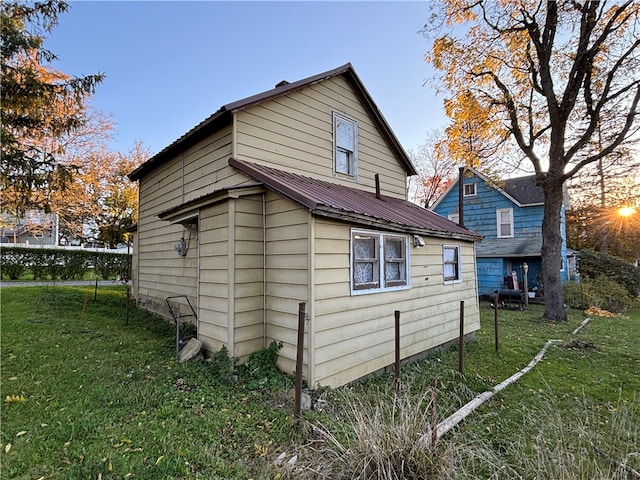 view of side of home featuring a yard