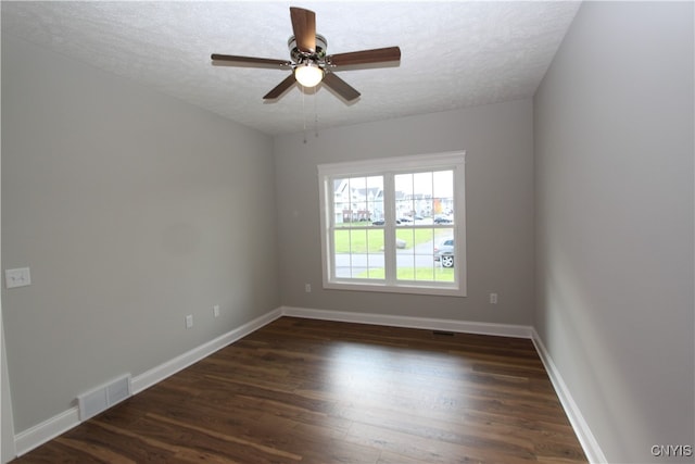 unfurnished room featuring ceiling fan, a textured ceiling, and dark hardwood / wood-style flooring