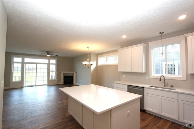 kitchen featuring white cabinetry, dark wood-type flooring, sink, and stainless steel dishwasher