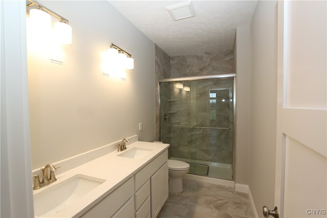 bathroom with vanity, a textured ceiling, toilet, and an enclosed shower