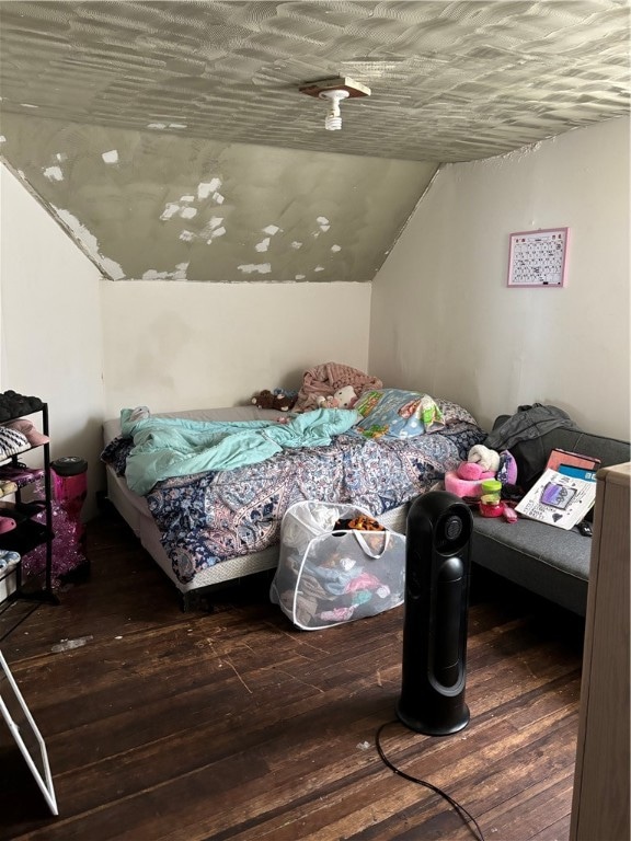 bedroom featuring lofted ceiling and dark hardwood / wood-style flooring