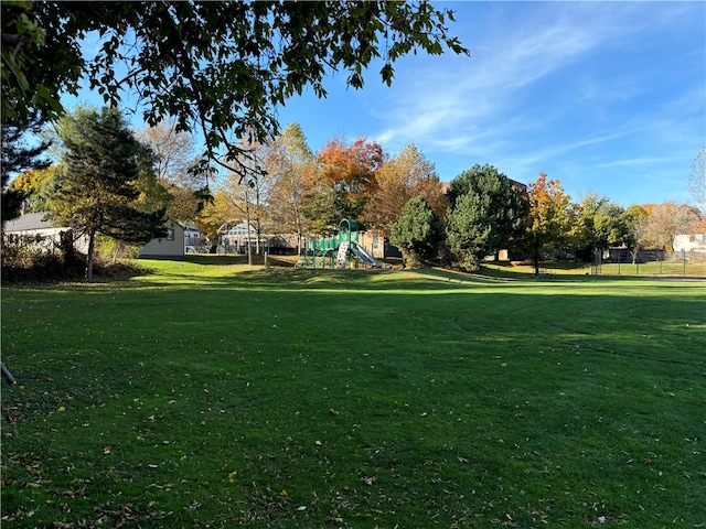 view of community featuring a playground and a lawn