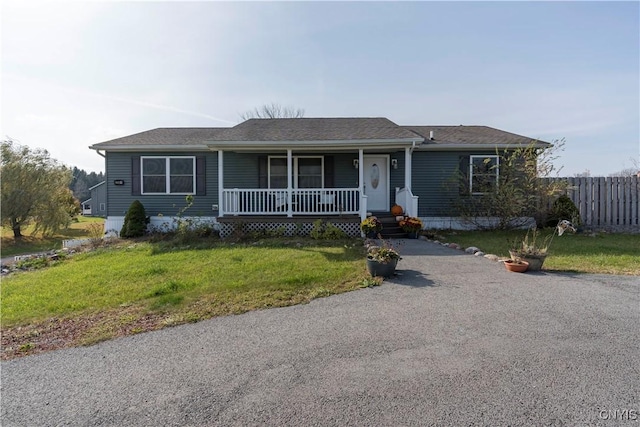 ranch-style house featuring a front lawn and a porch