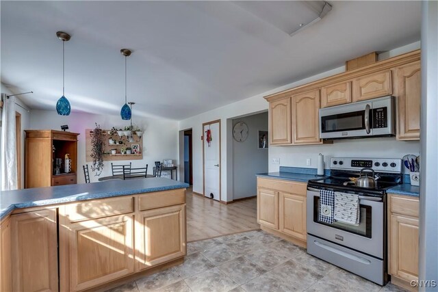 kitchen with pendant lighting, appliances with stainless steel finishes, and light brown cabinetry