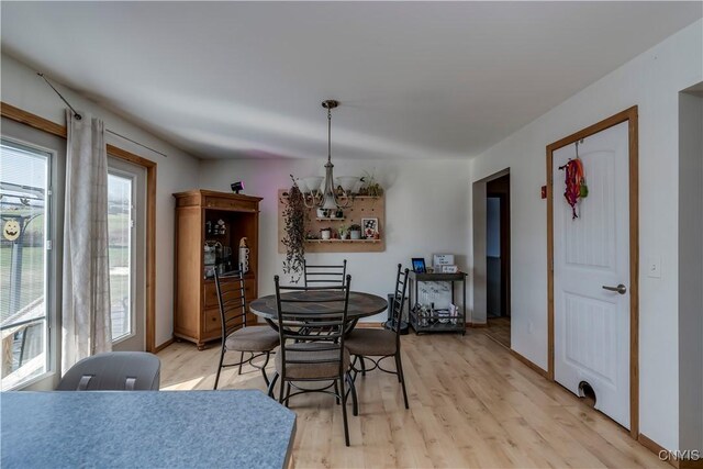 dining space featuring a chandelier and light hardwood / wood-style floors