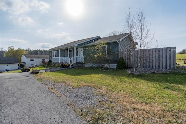 view of front of house with a front yard and covered porch