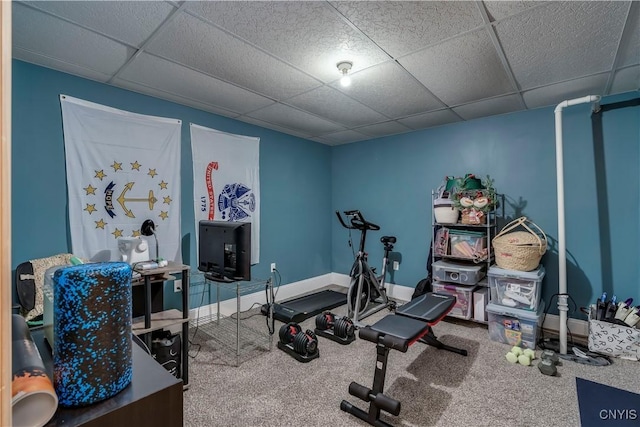 workout room featuring carpet floors and a paneled ceiling