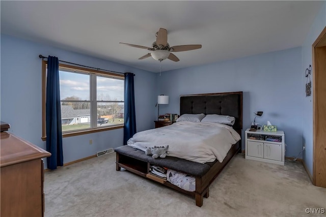 bedroom featuring ceiling fan and light carpet