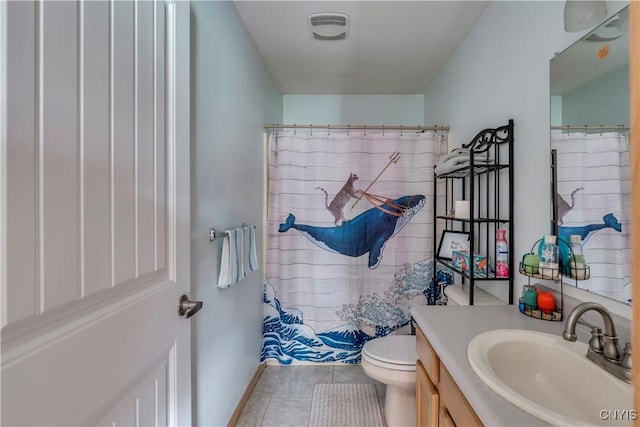 bathroom with vanity, tile patterned flooring, and toilet