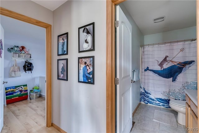 bathroom with vanity, curtained shower, and toilet