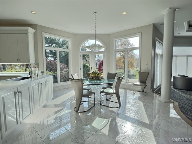 dining room with sink and ornate columns