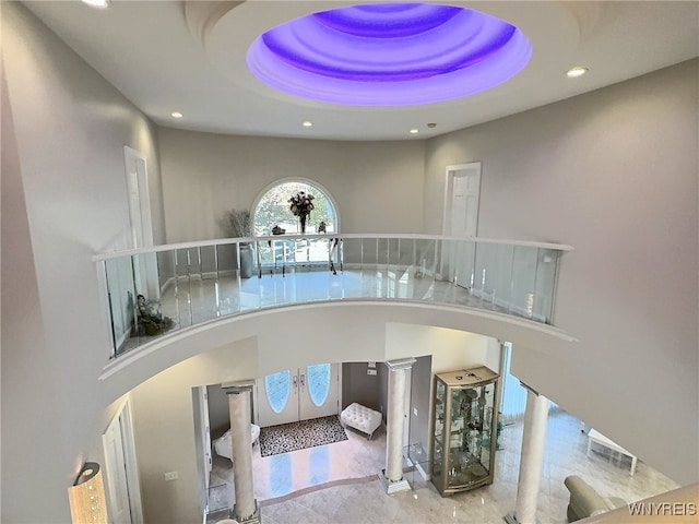 interior space with a raised ceiling and a high ceiling