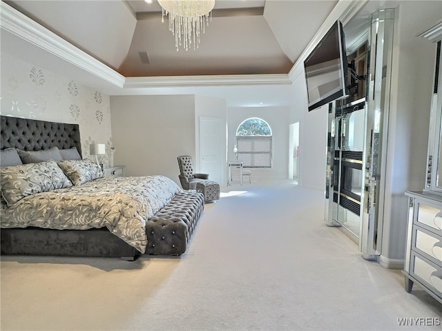 carpeted bedroom featuring an inviting chandelier, ornamental molding, a tray ceiling, and vaulted ceiling