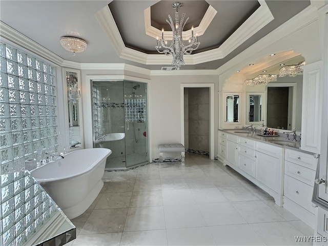 bathroom with separate shower and tub, an inviting chandelier, a tray ceiling, vanity, and tile patterned floors