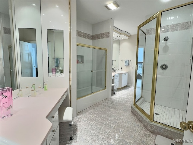 bathroom with vanity and shower / bath combination with glass door