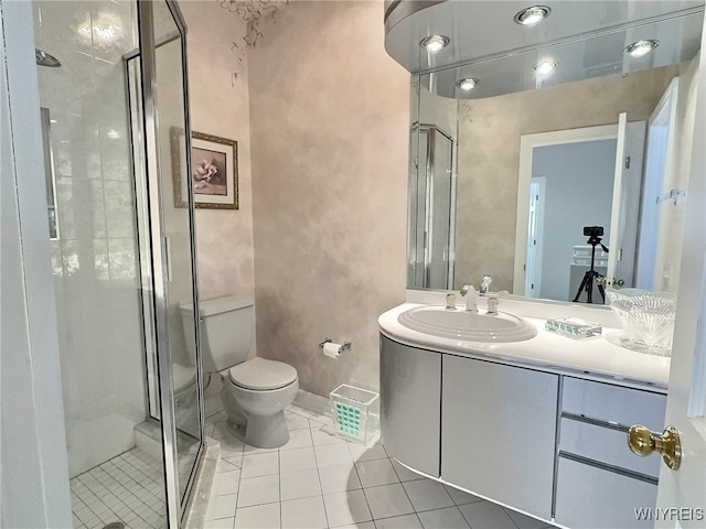 bathroom with vanity, a shower with shower door, toilet, and tile patterned flooring