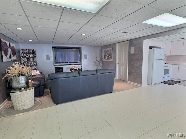 living room featuring a paneled ceiling and light colored carpet