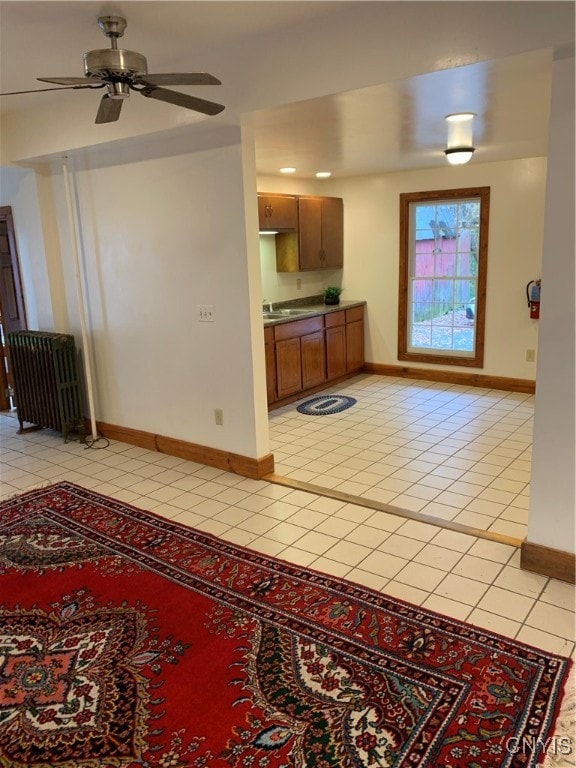 interior space featuring sink, radiator, and ceiling fan