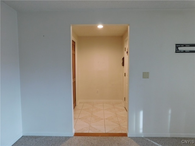 corridor with light tile patterned floors