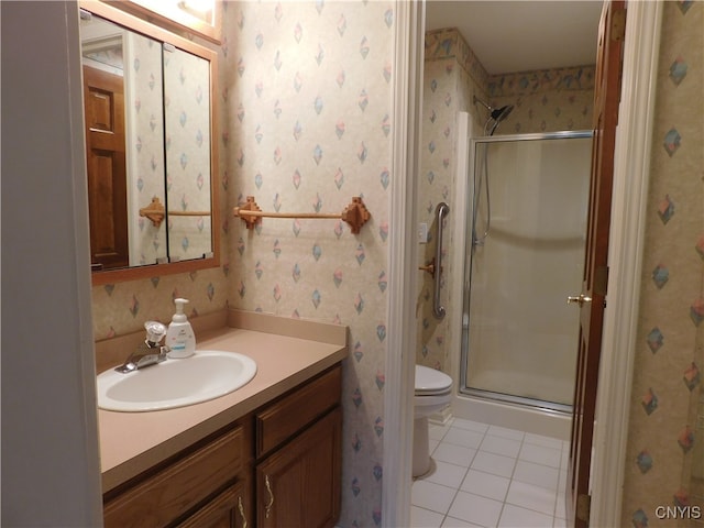 bathroom featuring toilet, an enclosed shower, vanity, and tile patterned flooring