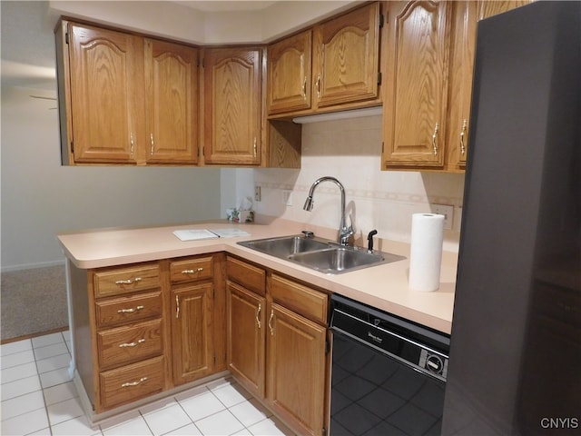 kitchen featuring stainless steel fridge, dishwasher, light tile patterned floors, and sink