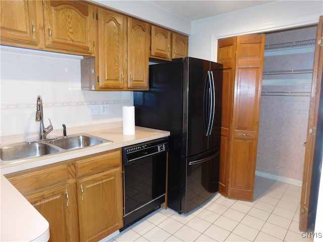 kitchen with light tile patterned floors, black appliances, sink, and decorative backsplash