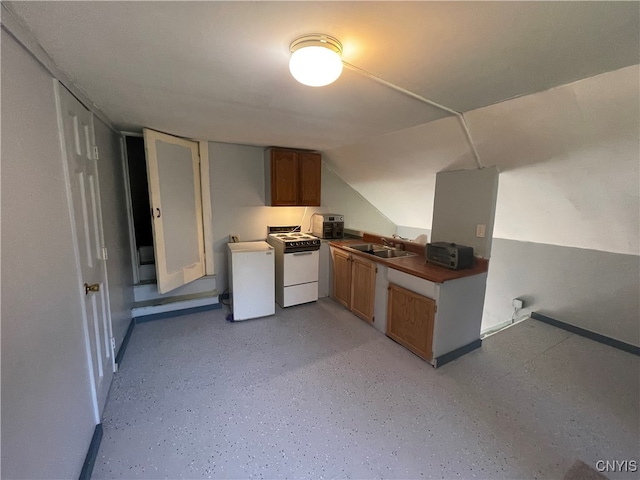 kitchen featuring sink and white range oven