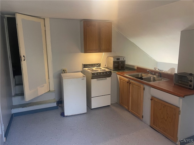 kitchen featuring sink, vaulted ceiling, and white appliances