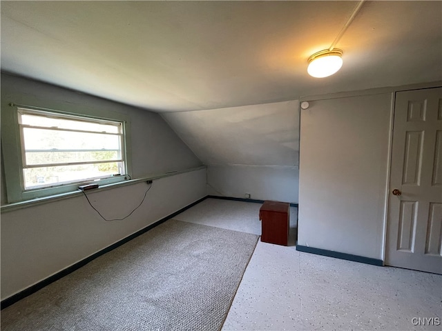 additional living space featuring lofted ceiling