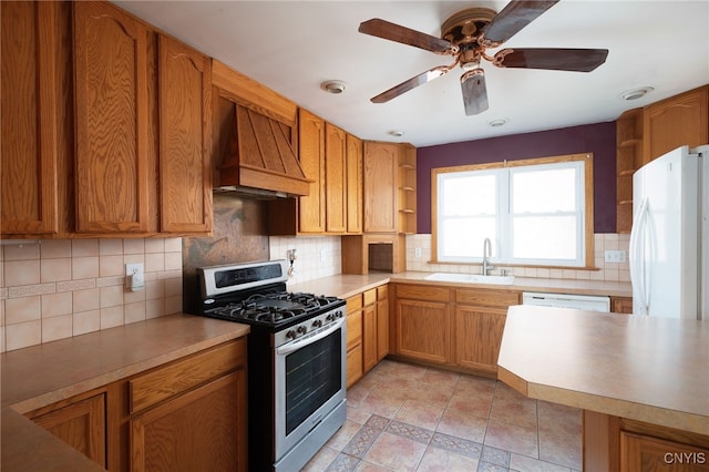 kitchen featuring white appliances, tasteful backsplash, sink, and custom exhaust hood