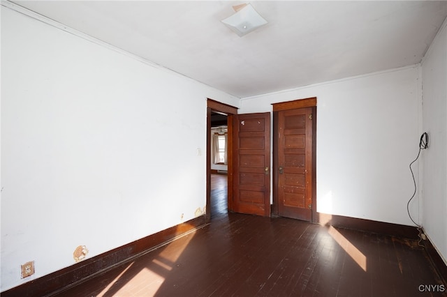 empty room with dark hardwood / wood-style flooring