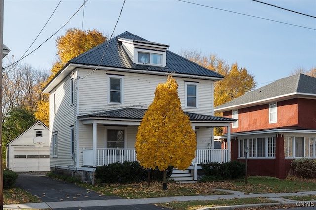 view of front of home with an outdoor structure, covered porch, and a garage