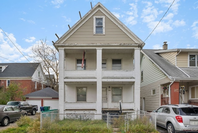 view of front of home with a balcony, a garage, and a porch