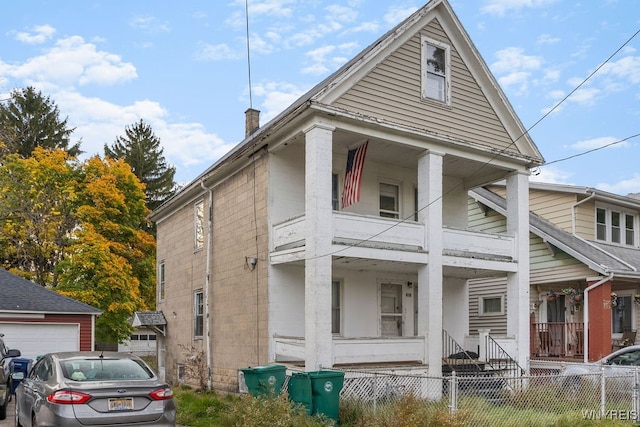 exterior space featuring covered porch and a balcony