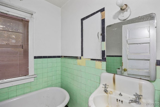 bathroom with tile walls and a washtub