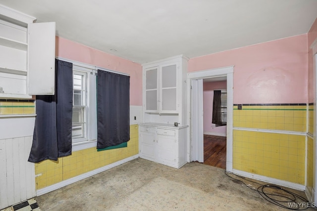 kitchen featuring white cabinets and radiator